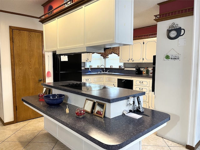 kitchen with a kitchen island, light tile patterned floors, sink, black appliances, and crown molding