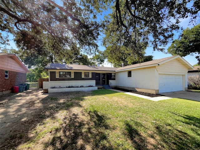 ranch-style house featuring a garage and a front yard