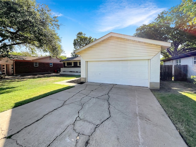 view of front of property with a front lawn and a garage