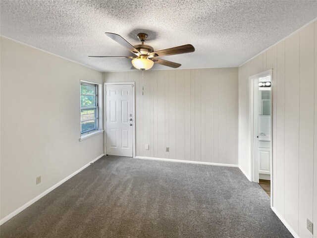 unfurnished bedroom with a textured ceiling, carpet floors, and ceiling fan