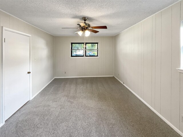 spare room featuring ceiling fan, carpet flooring, and a textured ceiling