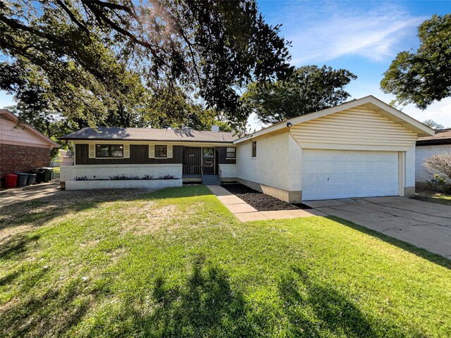 ranch-style home with a front yard and a garage