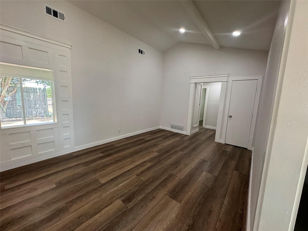 entryway featuring dark wood-type flooring and vaulted ceiling with beams