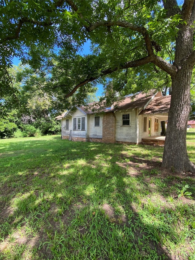 rear view of property with a lawn