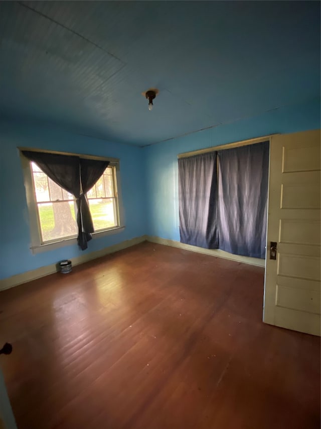 spare room with hardwood / wood-style flooring