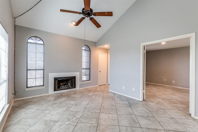 unfurnished living room featuring ceiling fan, light tile patterned floors, and high vaulted ceiling