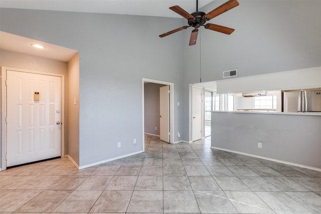 unfurnished living room with high vaulted ceiling, ceiling fan, and light tile patterned flooring