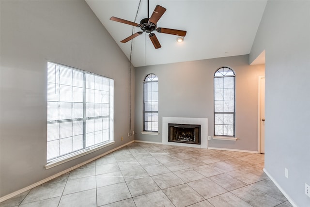 unfurnished living room featuring ceiling fan, light tile patterned floors, and high vaulted ceiling