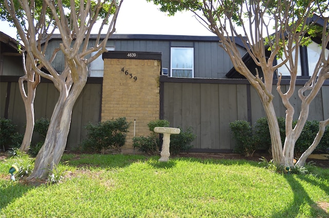 view of side of property with a lawn