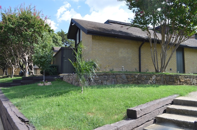 view of side of home featuring a lawn