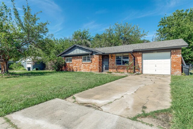 ranch-style house featuring a front yard and a garage