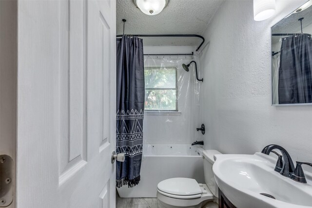 full bathroom featuring a textured ceiling, toilet, shower / tub combo, and vanity