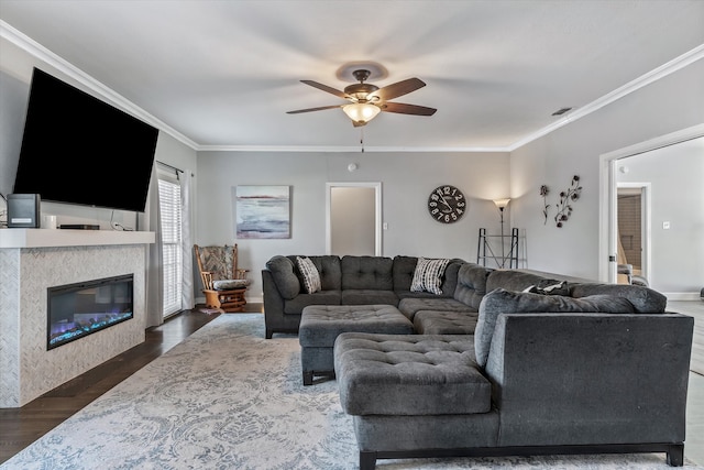 living room featuring ceiling fan, ornamental molding, and dark hardwood / wood-style flooring