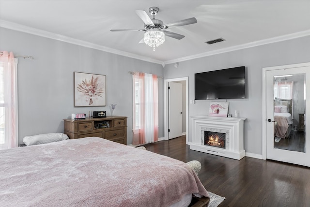 bedroom with ceiling fan, dark wood-type flooring, and ornamental molding