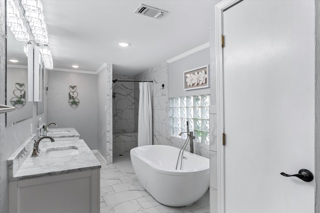 bathroom featuring ornamental molding, tile patterned floors, independent shower and bath, double sink vanity, and tile walls