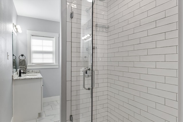 bathroom with tile patterned flooring, vanity, and walk in shower