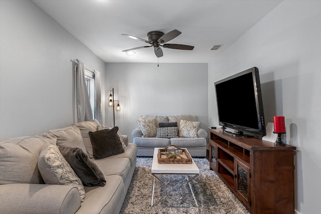 carpeted living room with ceiling fan