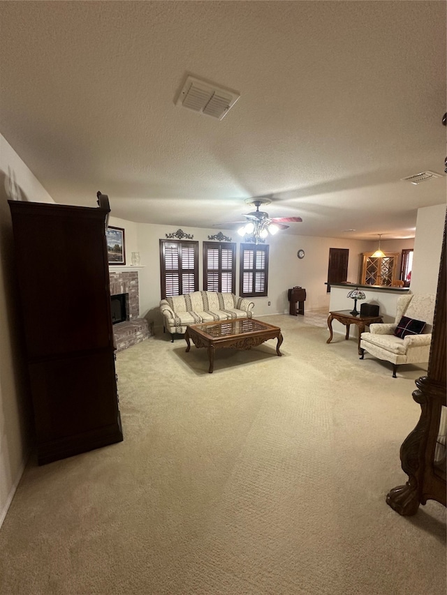 interior space with ceiling fan, carpet floors, and a brick fireplace