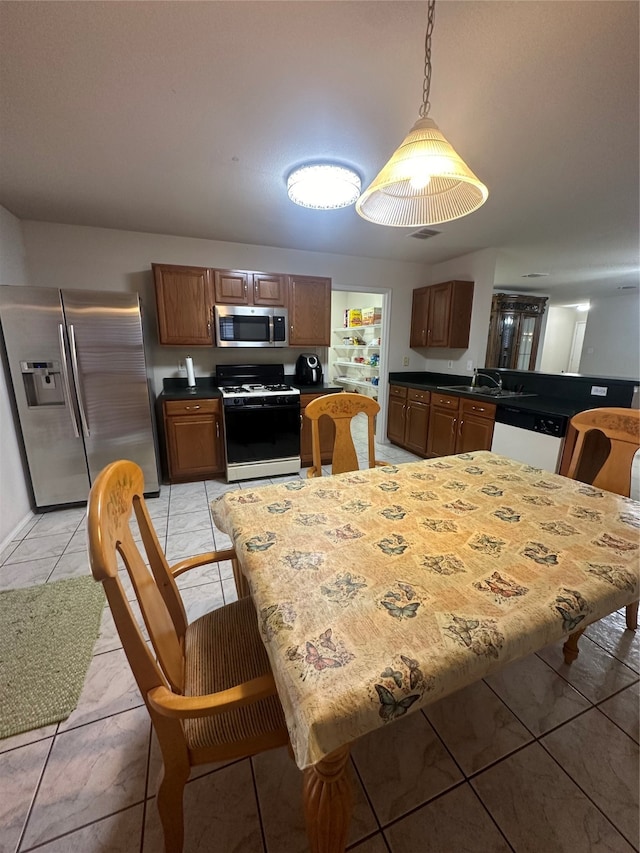 tiled dining space featuring sink