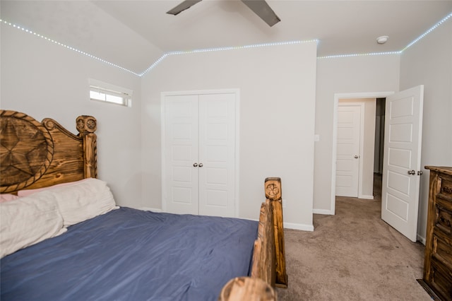 bedroom with ceiling fan, vaulted ceiling, carpet, and a closet