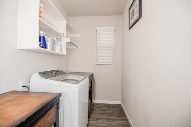 washroom featuring washing machine and dryer and dark hardwood / wood-style floors