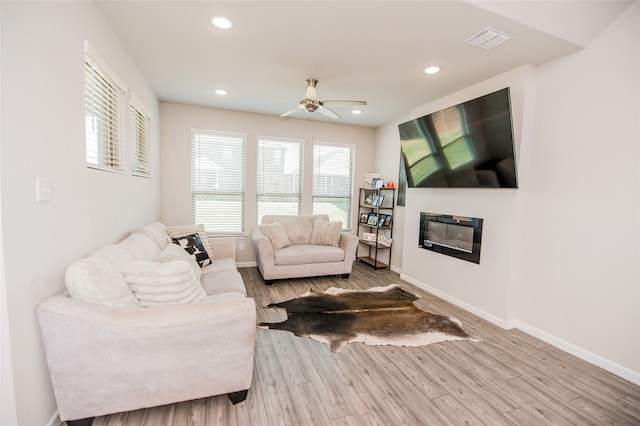 living room with ceiling fan and light hardwood / wood-style floors