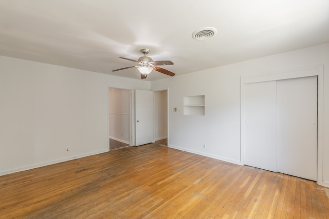 unfurnished bedroom with ceiling fan and light hardwood / wood-style floors