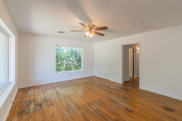 spare room featuring ceiling fan and dark hardwood / wood-style flooring