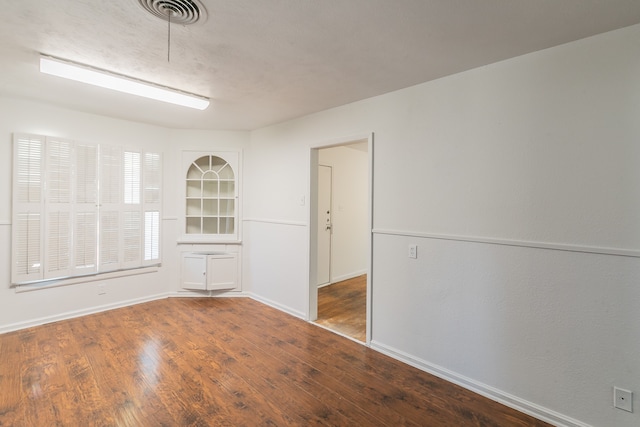 unfurnished room featuring hardwood / wood-style flooring