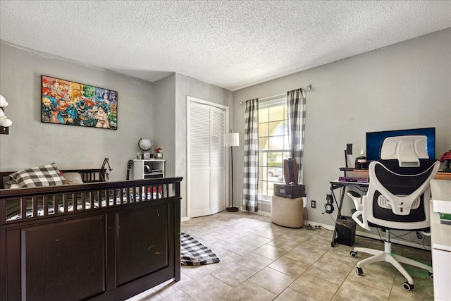 interior space with light tile patterned floors and a textured ceiling