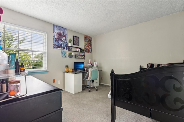 bedroom featuring light carpet and a textured ceiling