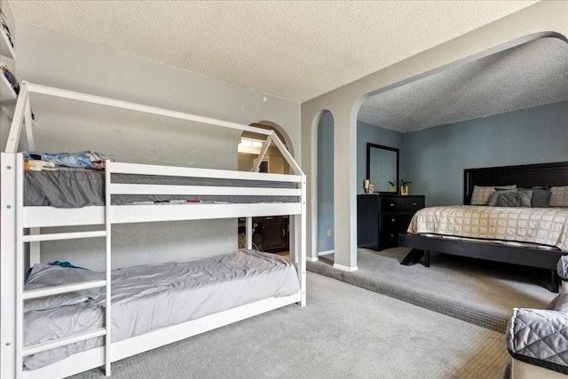 bedroom featuring carpet flooring and a textured ceiling