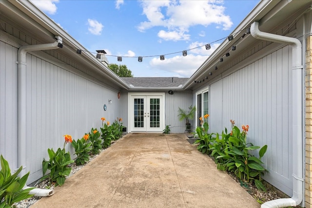 view of exterior entry featuring a patio area and french doors