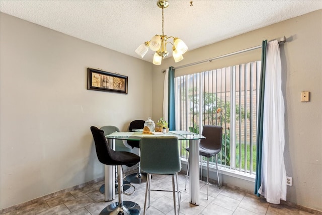 tiled dining area featuring a textured ceiling and a chandelier