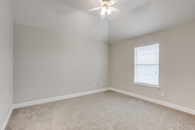 unfurnished room featuring ceiling fan, lofted ceiling, and light colored carpet