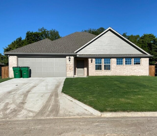 view of front of property with a garage and a front yard