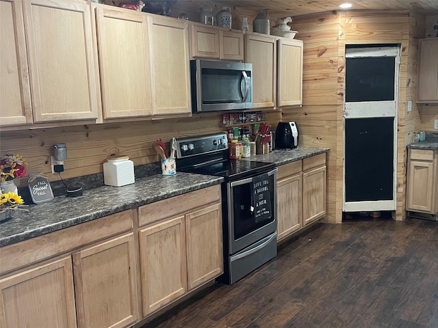 kitchen with wooden walls, light brown cabinets, wood ceiling, and appliances with stainless steel finishes