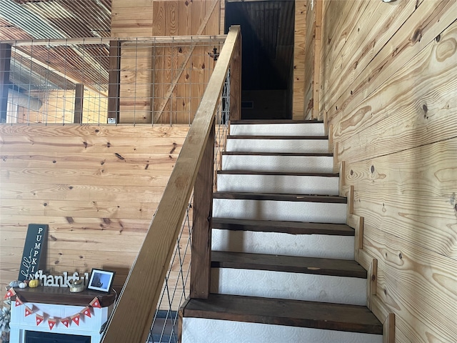 stairs featuring wooden walls