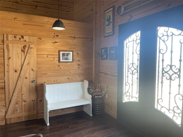 entrance foyer with dark hardwood / wood-style floors and wood walls