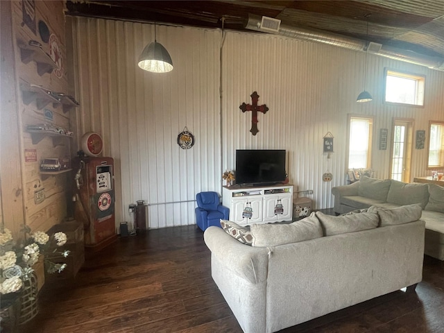 living room with wood walls and dark hardwood / wood-style flooring