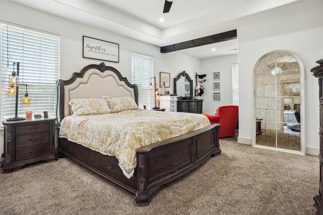 carpeted bedroom with ceiling fan and multiple windows