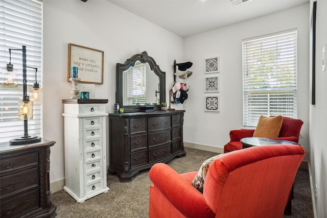 living area with dark carpet