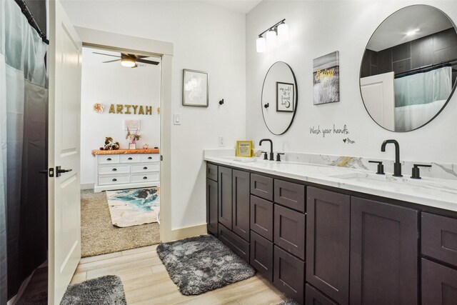 bathroom with a shower with shower curtain, hardwood / wood-style floors, vanity, and ceiling fan