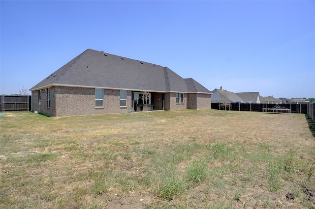 back of property featuring a lawn