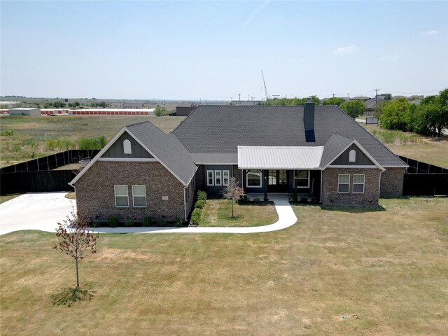 view of front of house with covered porch and a front lawn