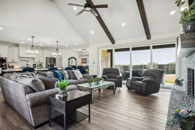 living room with a brick fireplace, light hardwood / wood-style flooring, high vaulted ceiling, and ceiling fan