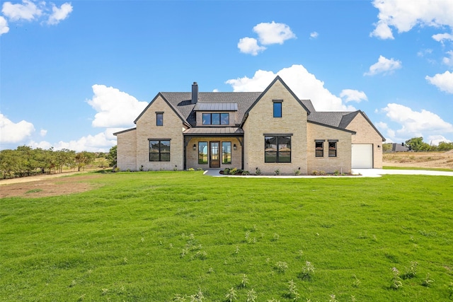 view of front of property featuring a front lawn and a garage