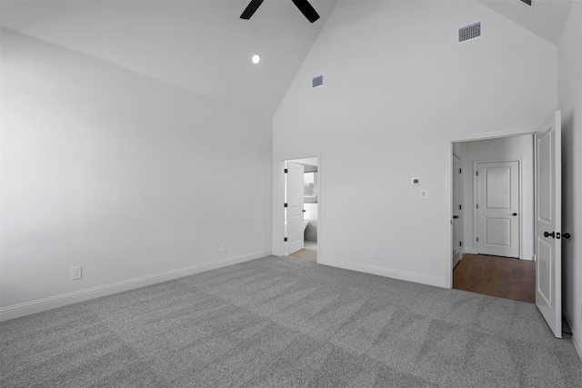 unfurnished bedroom with ceiling fan, high vaulted ceiling, connected bathroom, and carpet flooring