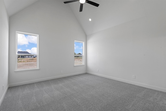 carpeted empty room with ceiling fan, high vaulted ceiling, and a healthy amount of sunlight