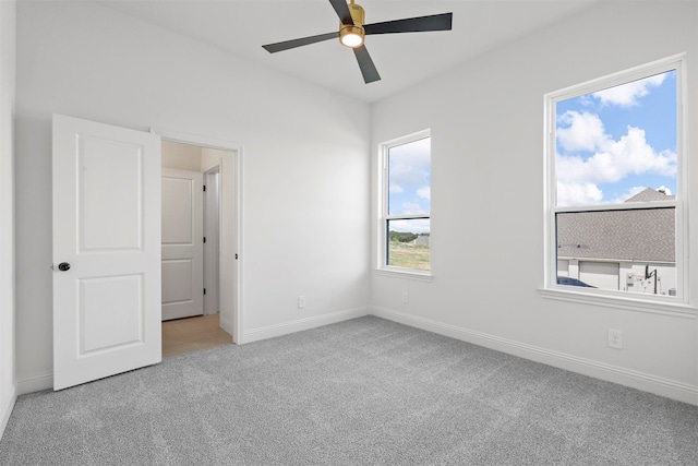 interior space featuring ceiling fan and light colored carpet